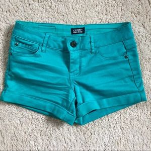 Teal colored jean shorts